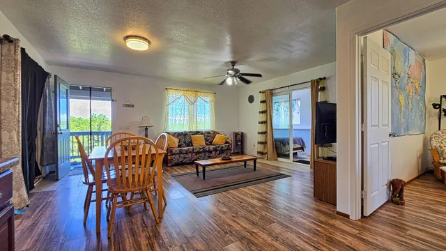 a living room with furniture and a wooden floor