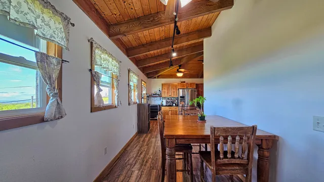 a view of a dining room with furniture and window