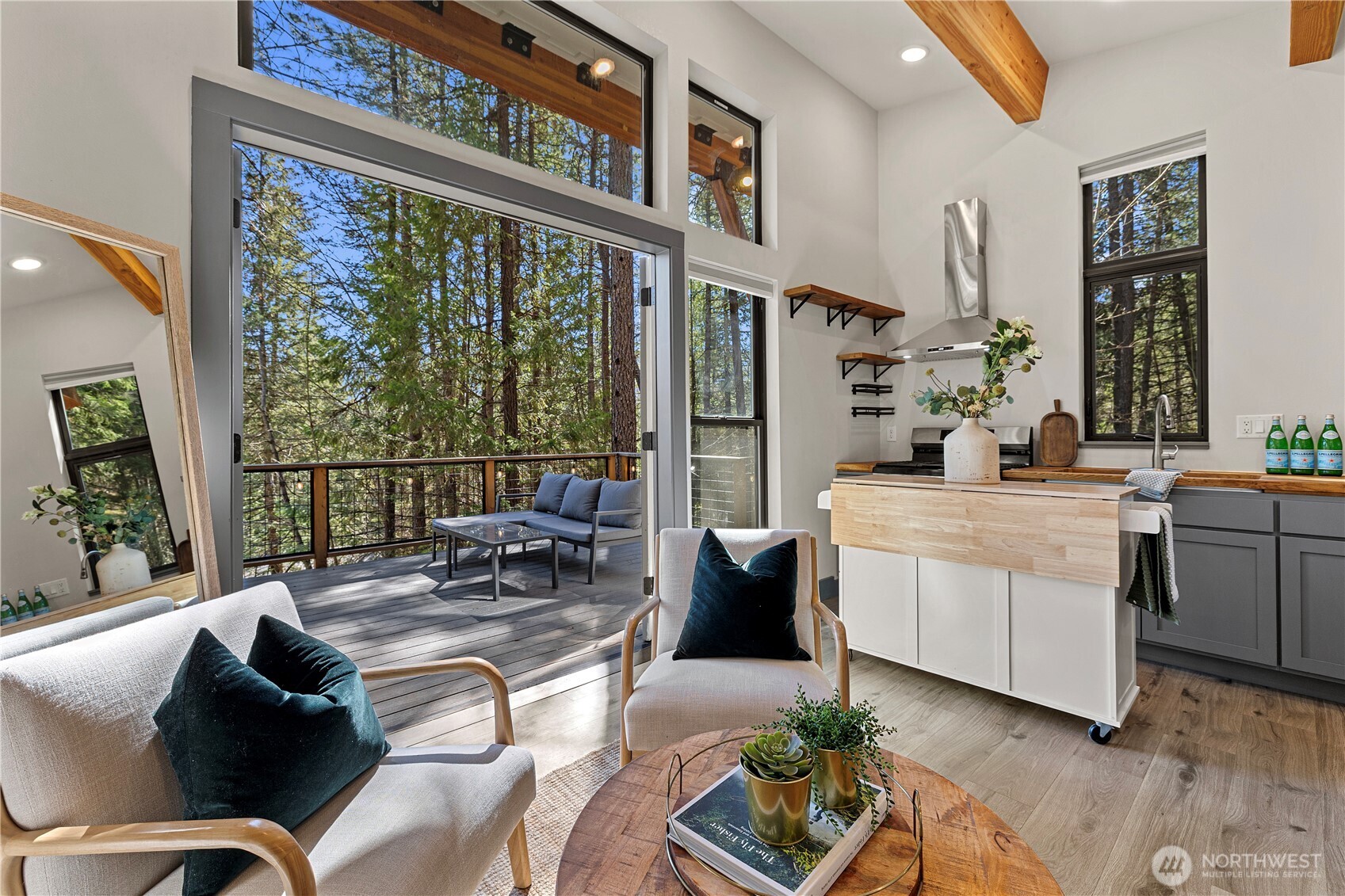 8056 Bayne Road Leavenworth, WA 98826 - Photo 13 of 40 a living room with furniture a large window and potted plants