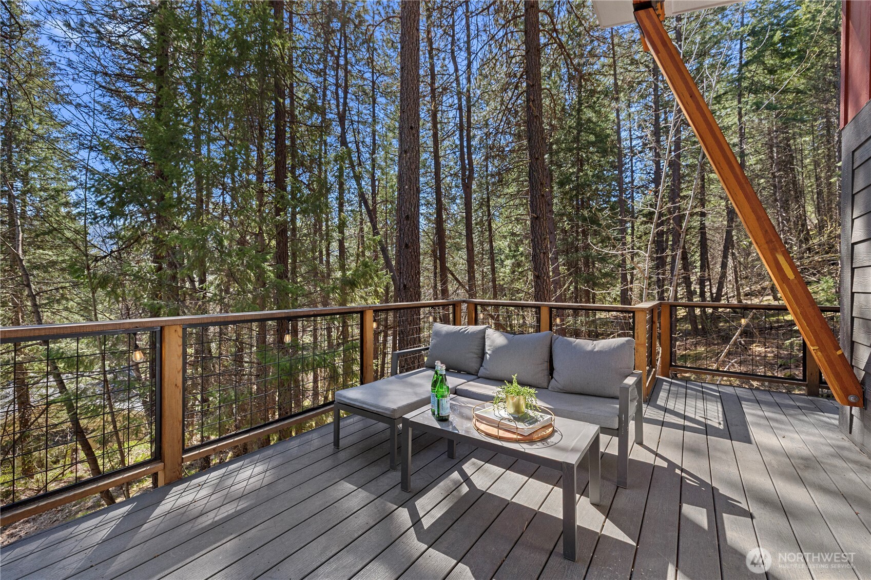 8056 Bayne Road Leavenworth, WA 98826 - Photo 23 of 40 a balcony with wooden floor and outdoor seating