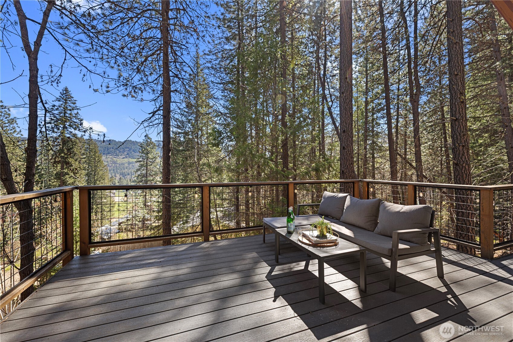 8056 Bayne Road Leavenworth, WA 98826 - Photo 25 of 40 a balcony with wooden floor and outdoor seating