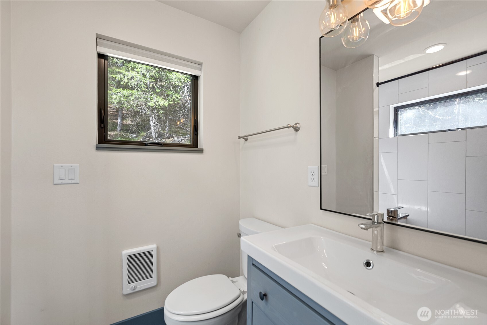 8056 Bayne Road Leavenworth, WA 98826 - Photo 28 of 40 a bathroom with a sink a toilet and mirror