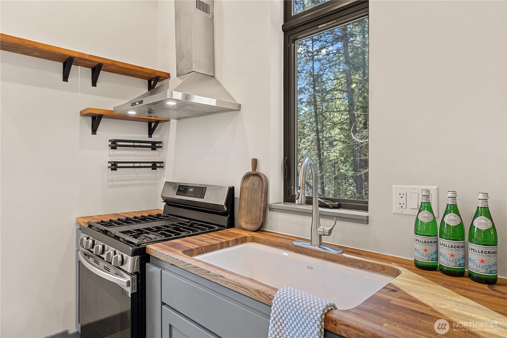 8056 Bayne Road Leavenworth, WA 98826 - Photo 7 of 40 a kitchen with stainless steel appliances a sink a stove and a window