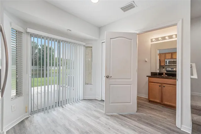 a view of a hallway with a kitchen space