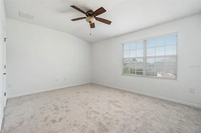 an empty room with a empty space and a ceiling fan
