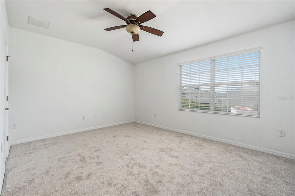 15854 Stable Run Drive Spring Hill, FL 34610 - Photo 14 of 28 an empty room with a empty space and a ceiling fan