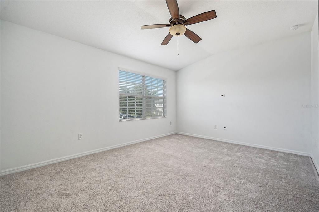 15854 Stable Run Drive Spring Hill, FL 34610 - Photo 15 of 28 an empty room with a window and a fan