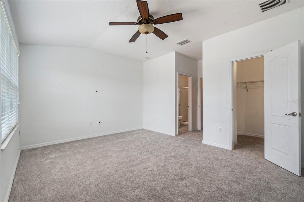 15854 Stable Run Drive Spring Hill, FL 34610 - Photo 16 of 28 an empty room with a ceiling fan and a window