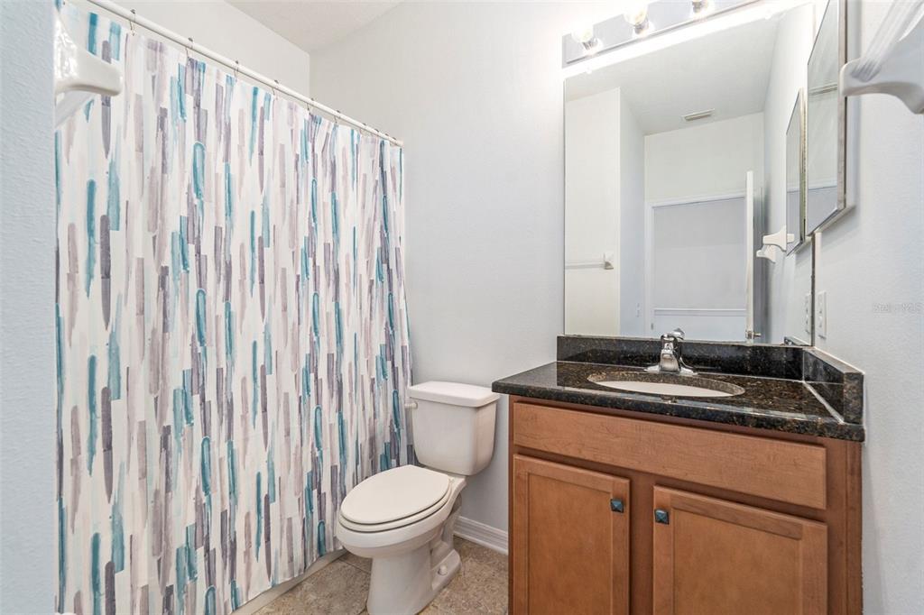 15854 Stable Run Drive Spring Hill, FL 34610 - Photo 17 of 28 a bathroom with a granite countertop sink and a mirror