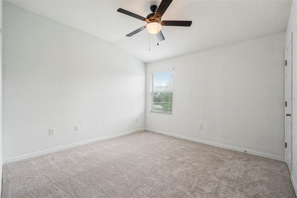 15854 Stable Run Drive Spring Hill, FL 34610 - Photo 18 of 28 an empty room with a window and a fan