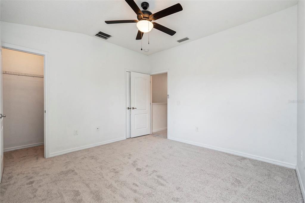 15854 Stable Run Drive Spring Hill, FL 34610 - Photo 19 of 28 an empty room with a ceiling fan and a window