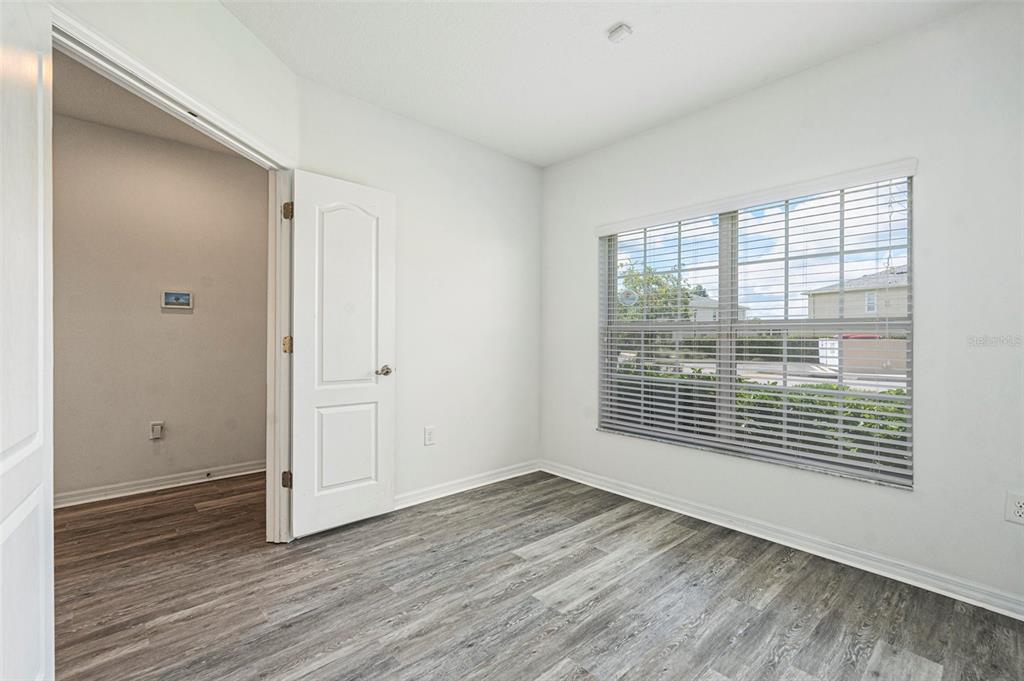 15854 Stable Run Drive Spring Hill, FL 34610 - Photo 21 of 28 a view of an empty room with wooden floor and a window