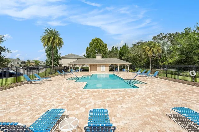 a house with swimming pool in front of it