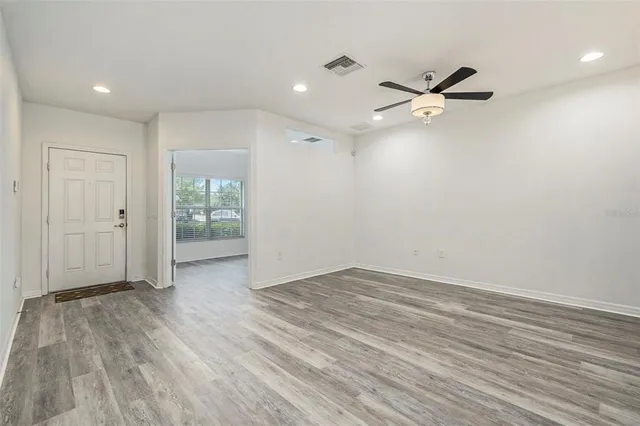 wooden floor in an empty room with a window