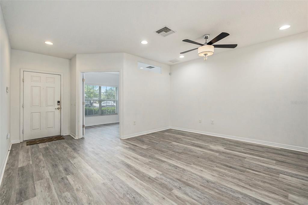 15854 Stable Run Drive Spring Hill, FL 34610 - Photo 4 of 28 wooden floor in an empty room with a window
