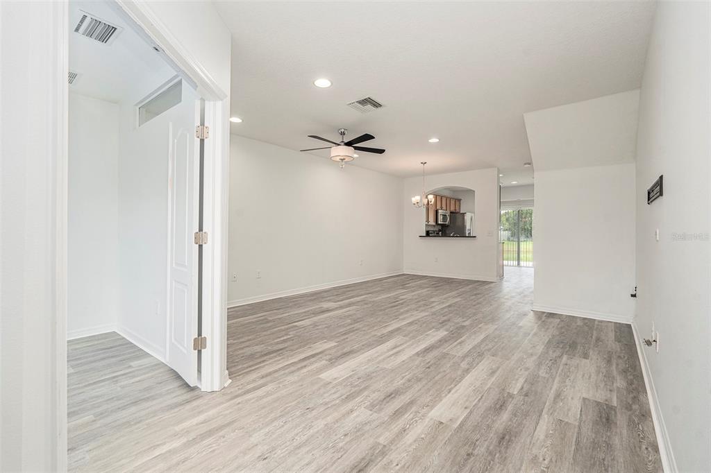 15854 Stable Run Drive Spring Hill, FL 34610 - Photo 5 of 28 a view of a big room with wooden floor and windows