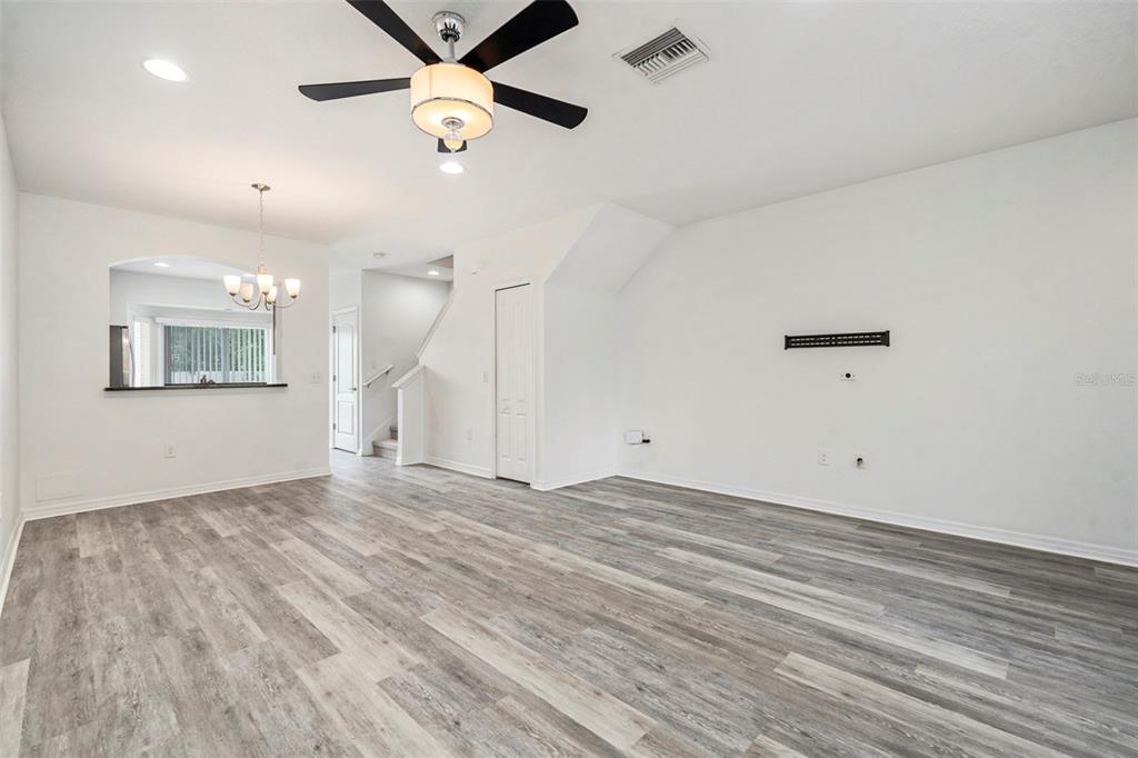 15854 Stable Run Drive Spring Hill, FL 34610 - Photo 6 of 28 wooden floor in an empty room with a window