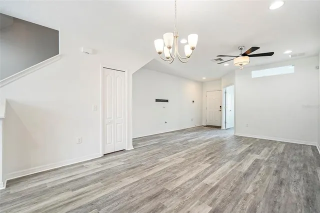 a view of a room with wooden floor and chandelier