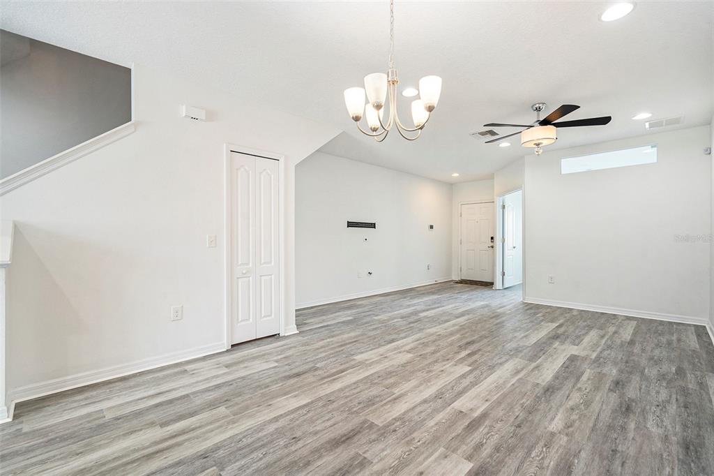 15854 Stable Run Drive Spring Hill, FL 34610 - Photo 7 of 28 a view of a room with wooden floor and chandelier