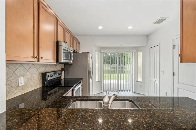 a view of a kitchen with a sink and cabinets