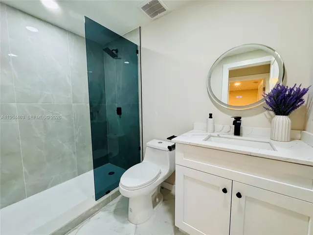 a white house that has tree in front of it