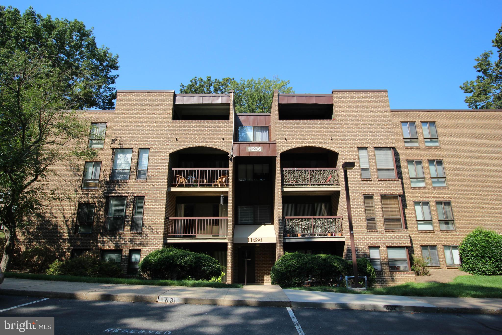 11236 Chestnut Grove Square, Unit 163 Reston, VA 20190 - Photo 1 of 4 Backside of building. Balcony view overlook trees