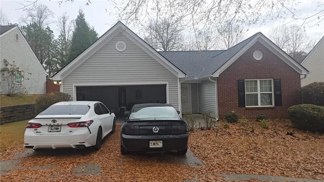 a car parked in front of white house
