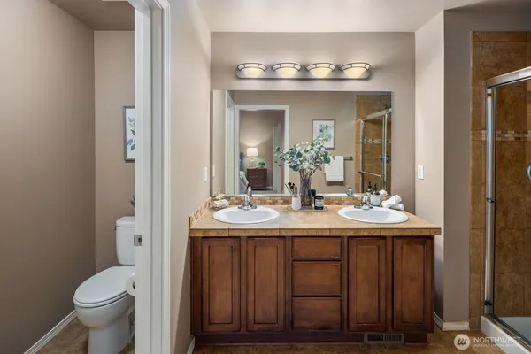 a bathroom with a toilet a sink and mirror