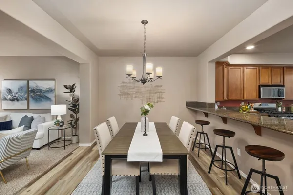 a view of a dining room with furniture window and wooden floor
