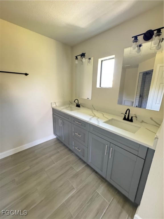 6108 Holt Court Fort Myers, FL 33905 - Photo 11 of 19 a bathroom with a double vanity sink and mirror