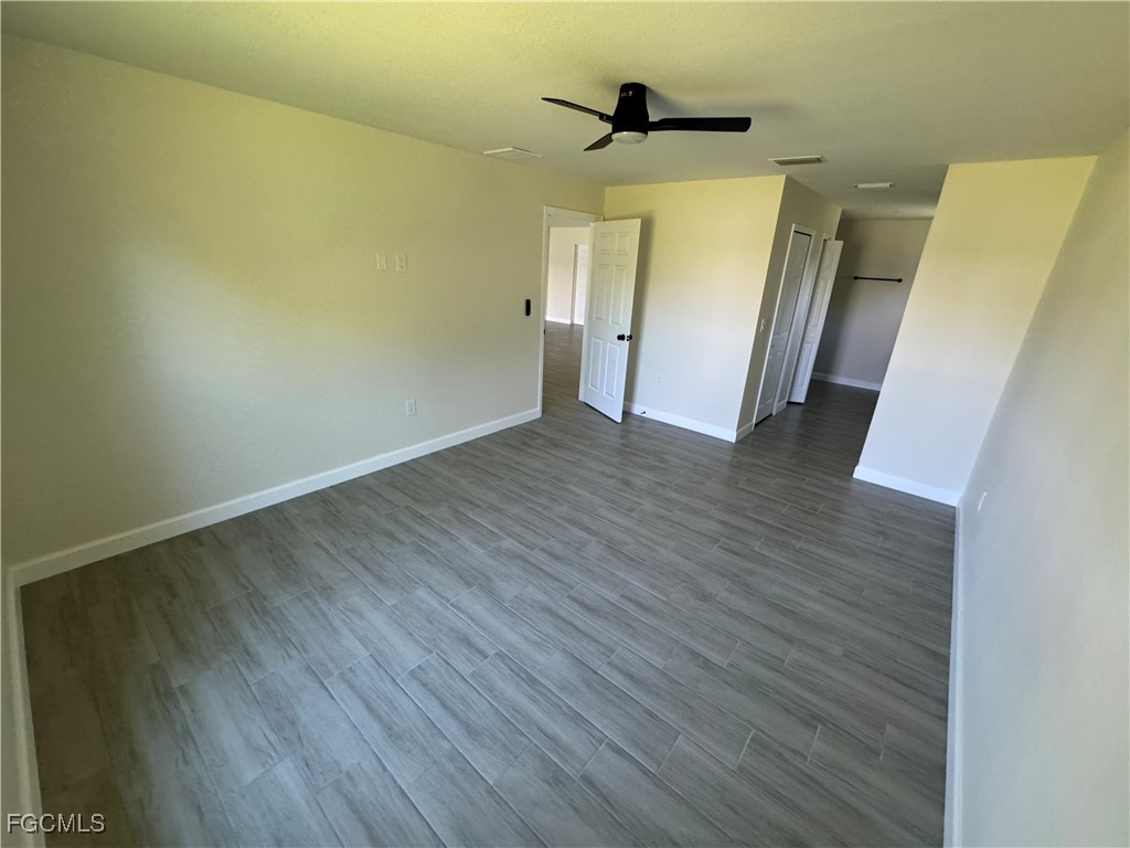 6108 Holt Court Fort Myers, FL 33905 - Photo 13 of 19 a view of empty room with wooden floor and fan