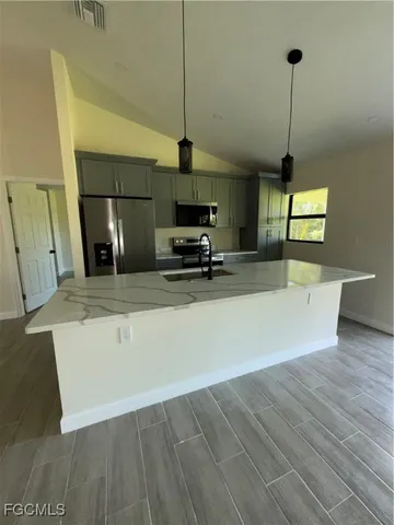 a view of a kitchen with a sink a and a ceiling fan