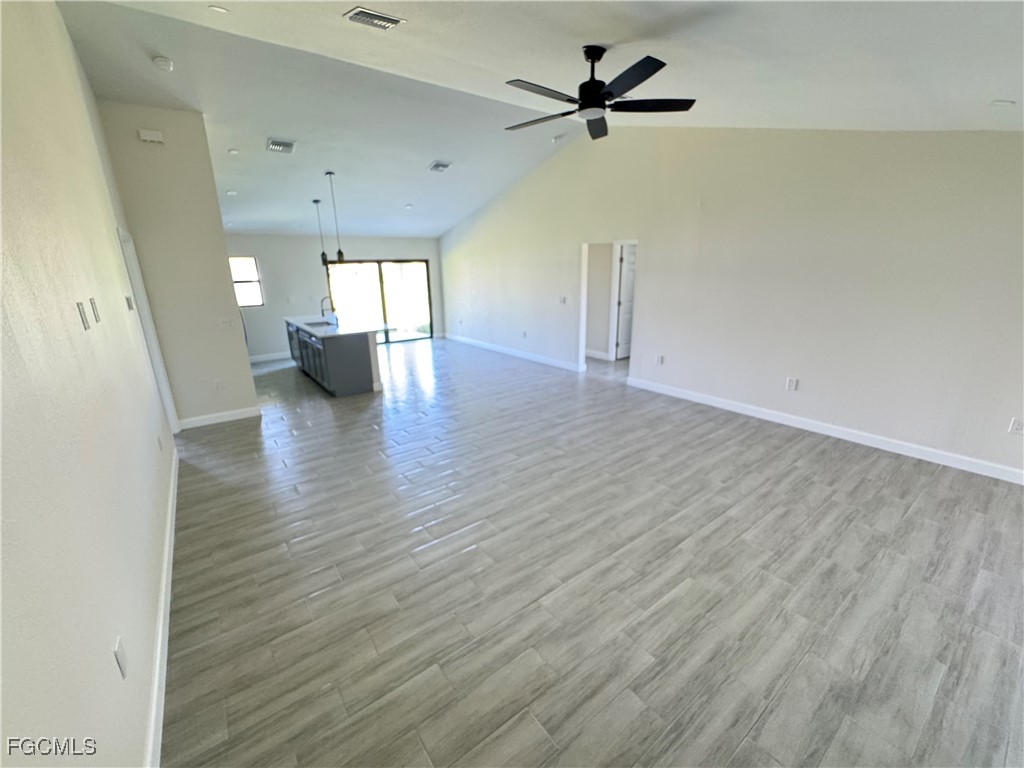 6108 Holt Court Fort Myers, FL 33905 - Photo 6 of 19 wooden floor in an empty room with a window
