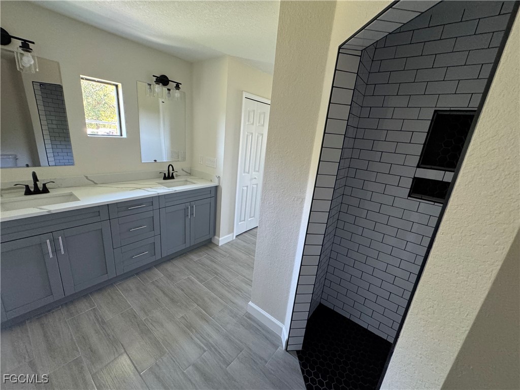 6108 Holt Court Fort Myers, FL 33905 - Photo 9 of 19 a bathroom with a sink a mirror and tub
