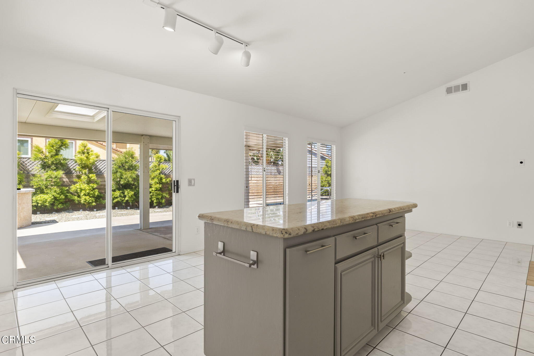 2710 Windcrest Place Oxnard, CA 93036 - Photo 12 of 34 a kitchen with granite countertop a sink and a refrigerator