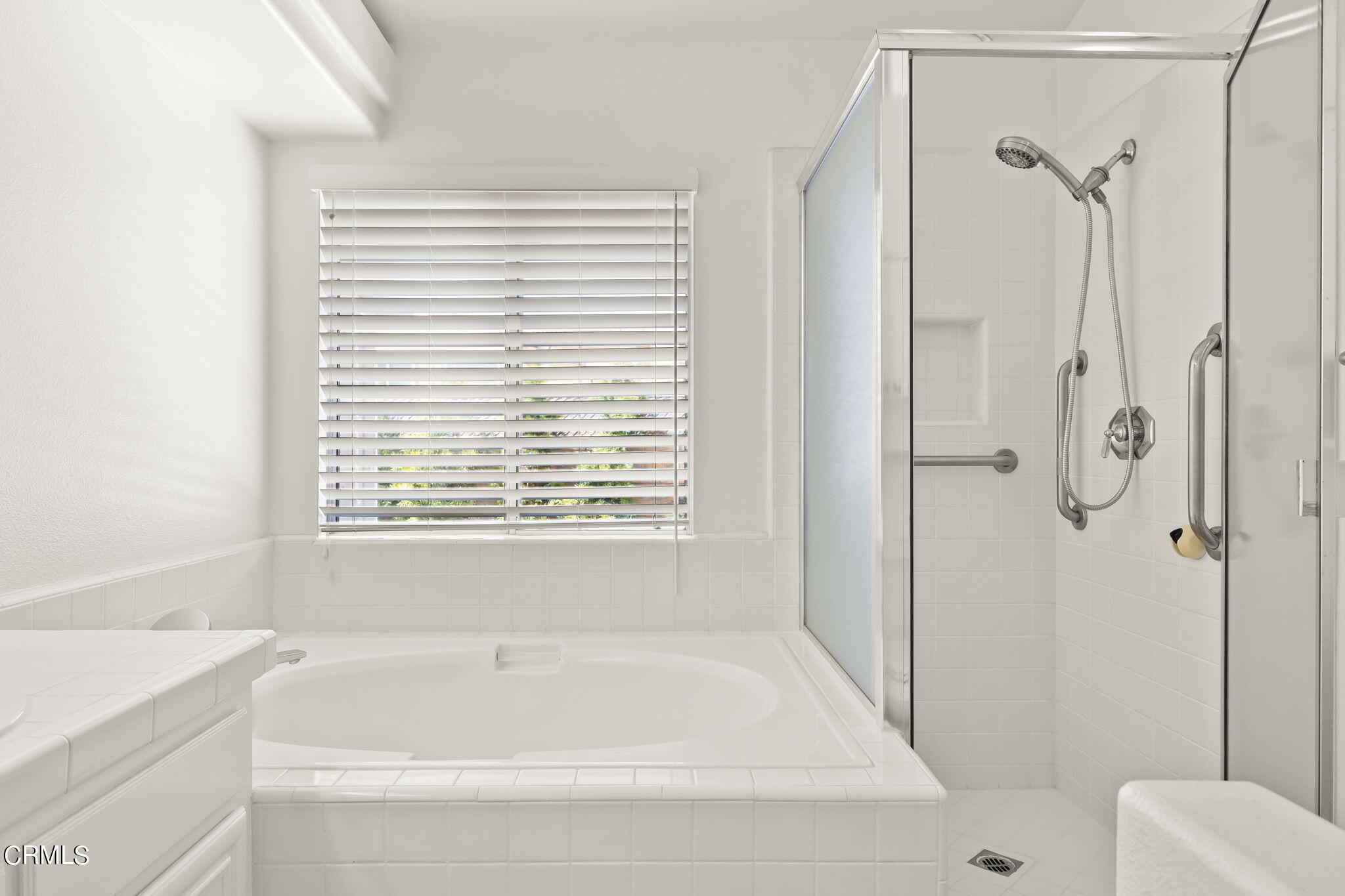 2710 Windcrest Place Oxnard, CA 93036 - Photo 16 of 34 a bathroom with a bathtub and shower