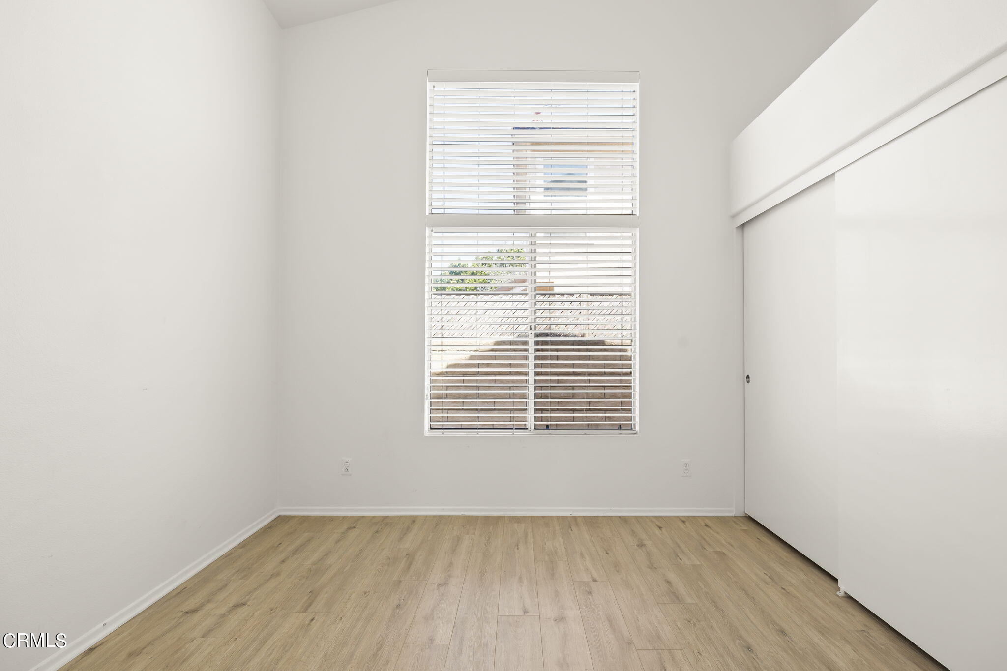 2710 Windcrest Place Oxnard, CA 93036 - Photo 17 of 34 a view of an empty room with wooden floor and a window