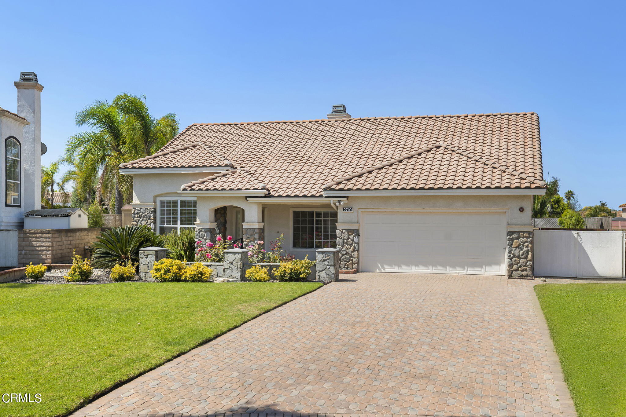 2710 Windcrest Place Oxnard, CA 93036 - Photo 2 of 34 a front view of a house with a yard and garage