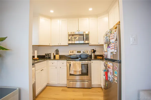 a kitchen with stainless steel appliances granite countertop a stove and a sink