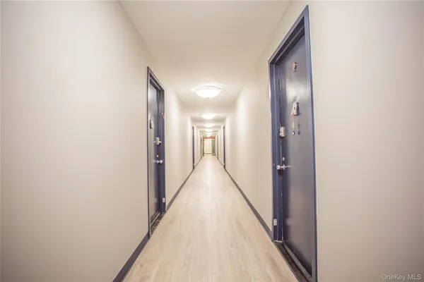 a view of hallway with wooden floor