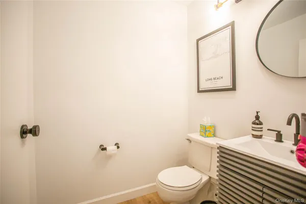 a white toilet sitting next to a bathroom sink