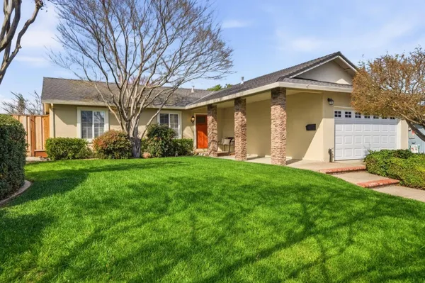 a front view of house with yard and green space