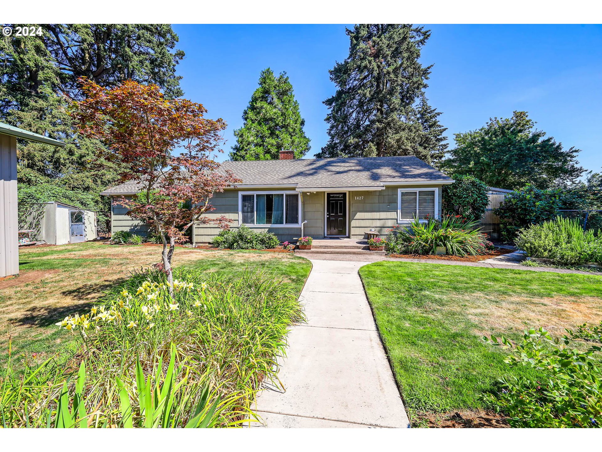 1427 Anderson Lane Springfield, OR 97477 - Photo 1 of 48 a front view of a house with a yard table and chairs