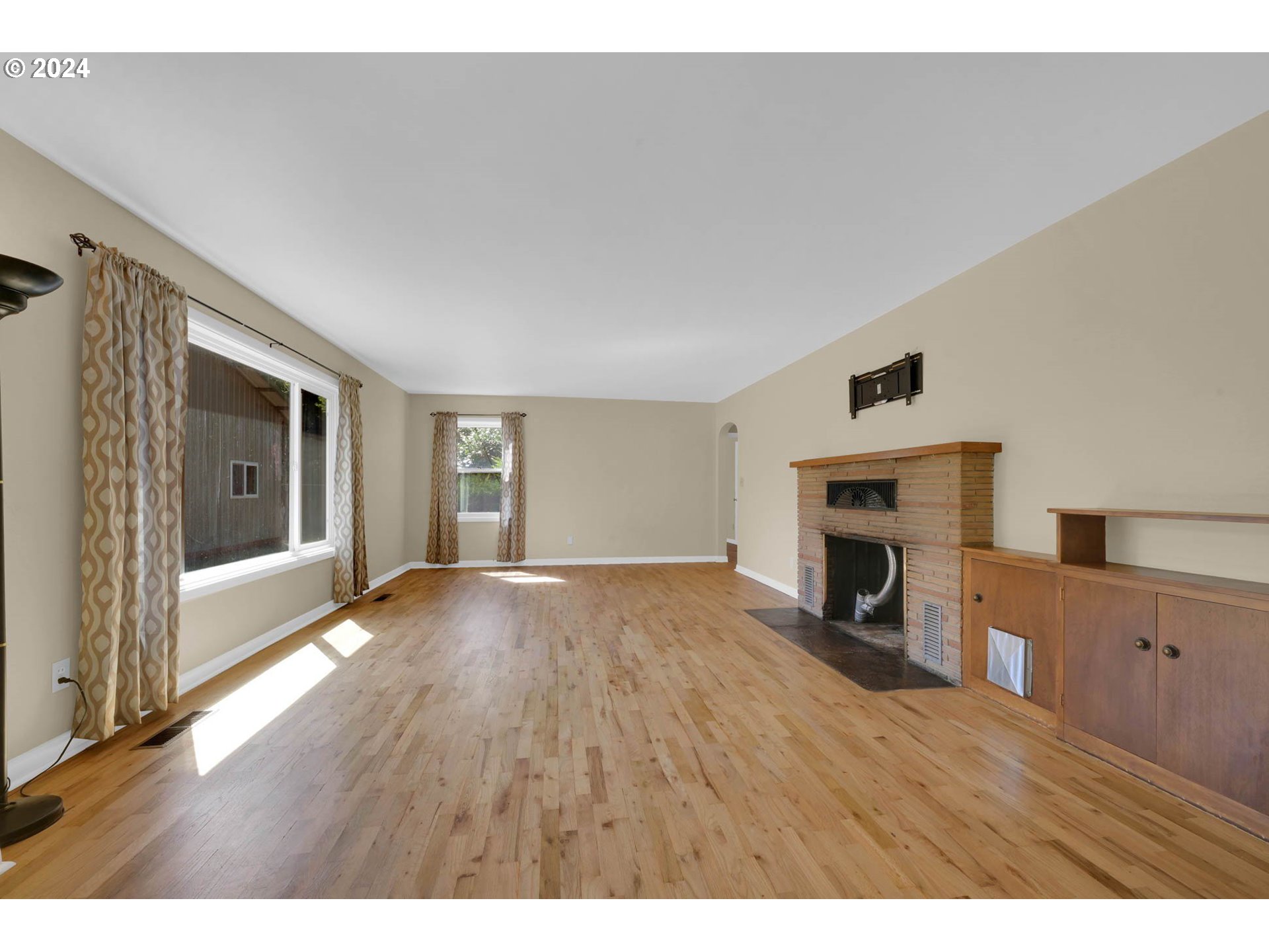 1427 Anderson Lane Springfield, OR 97477 - Photo 10 of 48 a view of empty room with a fireplace and wooden floor