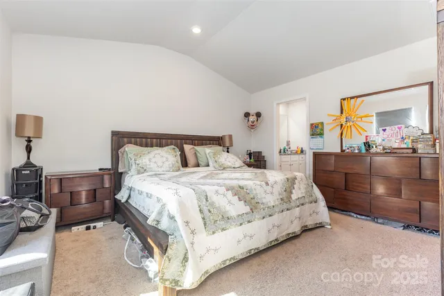 a bedroom with a bed and dresser with mirror