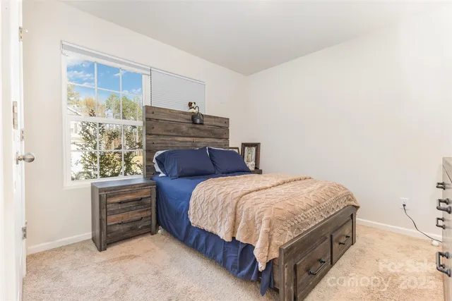 a bed sitting in a bedroom next to a window