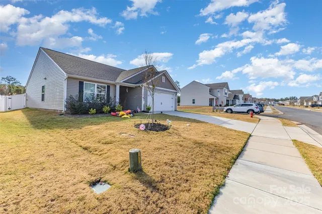 a view of swimming pool in front of residential houses with yard