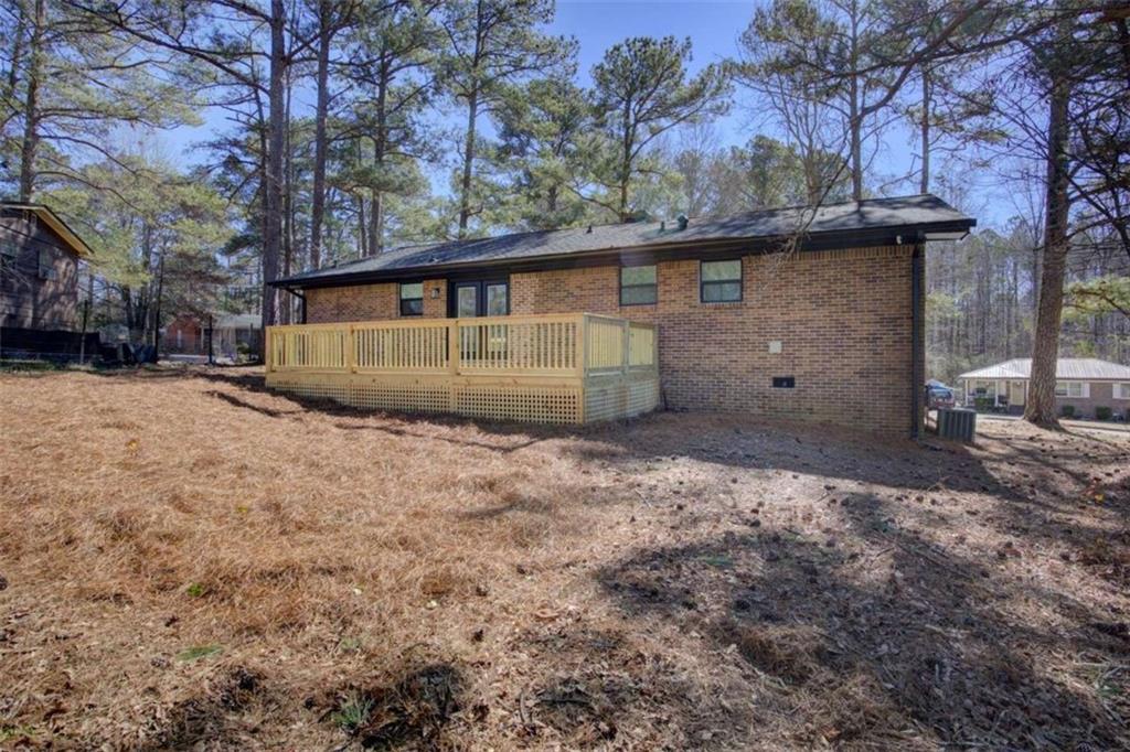 7225 Pineneedle Drive Southwest Covington, GA 30014 - Photo 33 of 37 a view of a house with backyard and trees