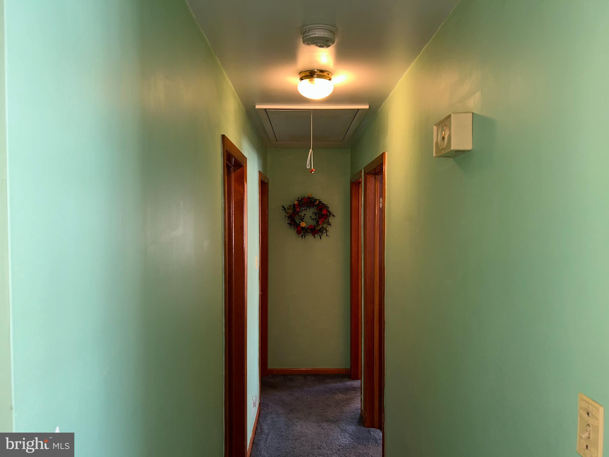 144 Annapolis Road Pennsville, NJ 08070 - Photo 13 of 24 hallway with wooden floor and a bathroom