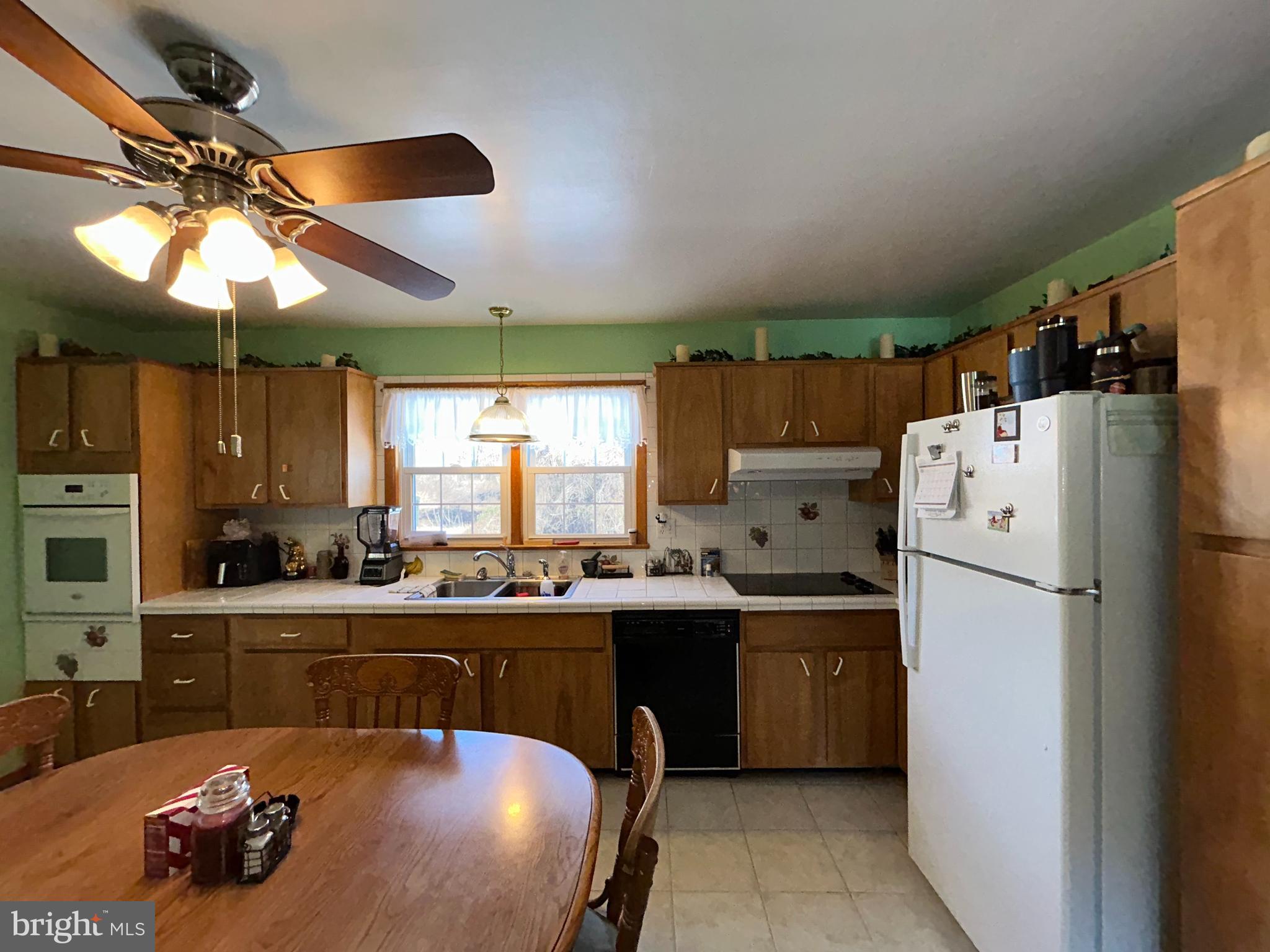 144 Annapolis Road Pennsville, NJ 08070 - Photo 14 of 24 a kitchen with a sink a stove and a refrigerator